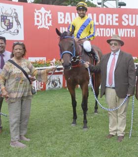 Sharmila Padmanabhan and trainer James McKeown leading in Royal Legacy (Vivek G up), winner of Karnataka Governor`s Trophy at Bangalore on Friday.